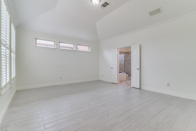 unfurnished room with light wood-style flooring, baseboards, ornamental molding, and high vaulted ceiling