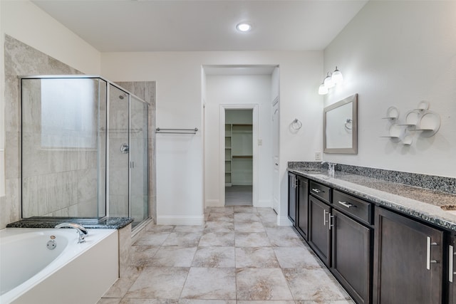 bathroom with vanity and separate shower and tub