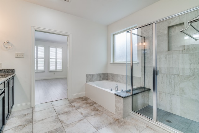 bathroom with vanity, plus walk in shower, and a healthy amount of sunlight