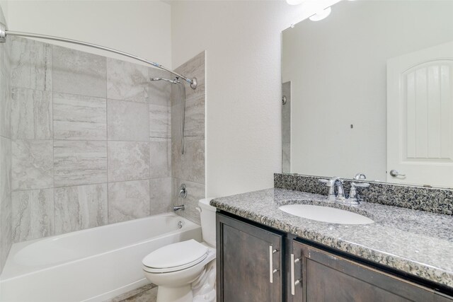 full bath featuring toilet, vanity, and bathing tub / shower combination