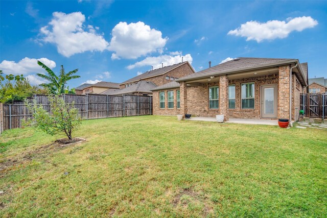 rear view of property with a patio and brick siding