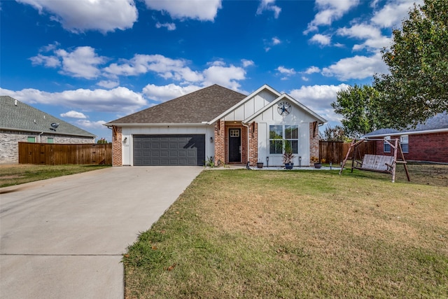 view of front of property with a garage and a front lawn