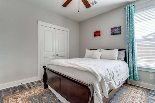 bedroom featuring ceiling fan, a closet, and hardwood / wood-style flooring