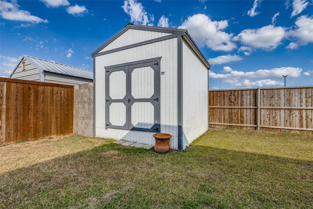 view of outbuilding with a yard