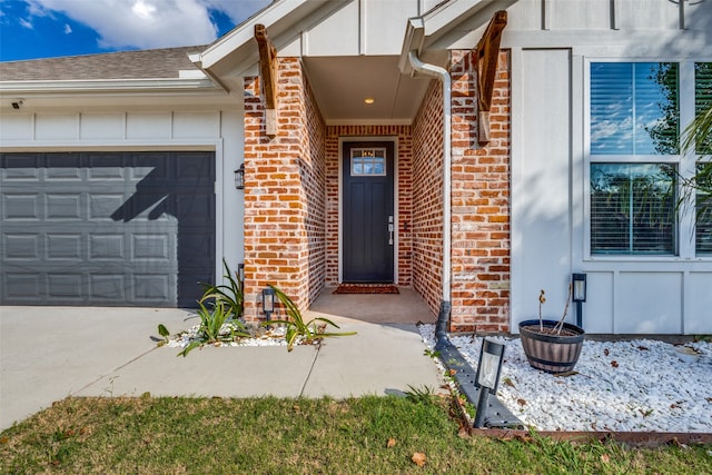 view of exterior entry with a garage