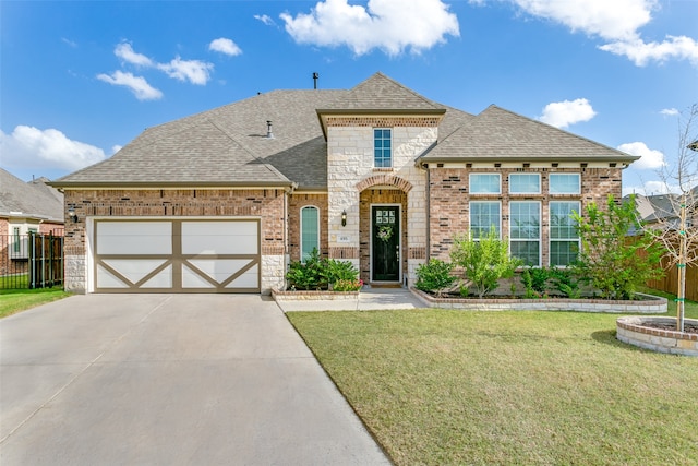 view of front of property featuring a front yard and a garage