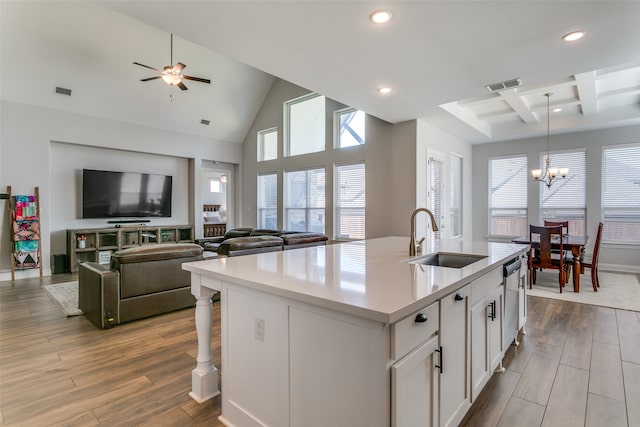 kitchen with light hardwood / wood-style flooring, a center island with sink, sink, plenty of natural light, and white cabinets