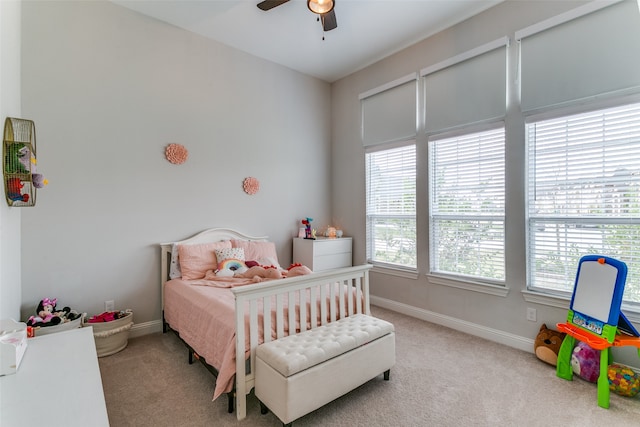 bedroom featuring light colored carpet and ceiling fan