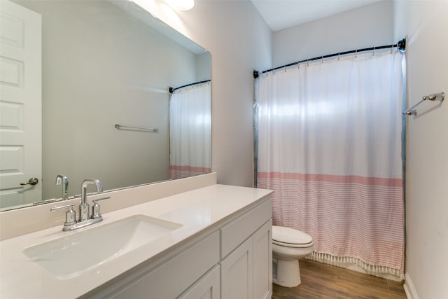 bathroom featuring vanity, toilet, a shower with curtain, and hardwood / wood-style floors