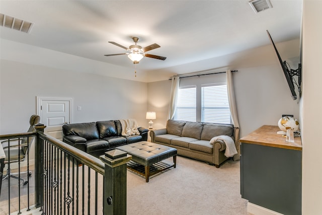 carpeted living room featuring ceiling fan