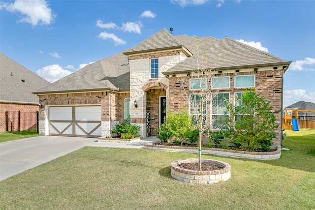 view of front facade featuring a front yard and a garage