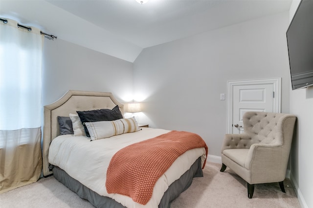 carpeted bedroom featuring vaulted ceiling