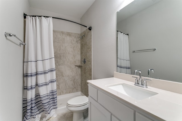 bathroom featuring vanity, toilet, and curtained shower