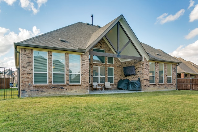 rear view of house with a patio area and a lawn