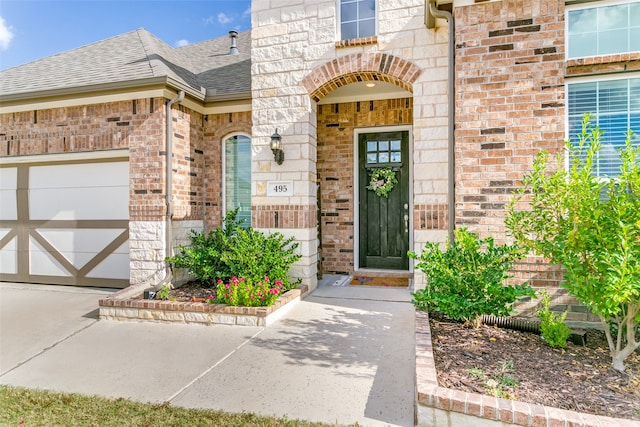 view of exterior entry featuring a garage