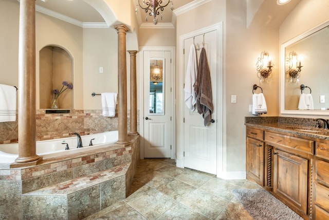 bathroom featuring vanity, decorative columns, crown molding, and tiled tub