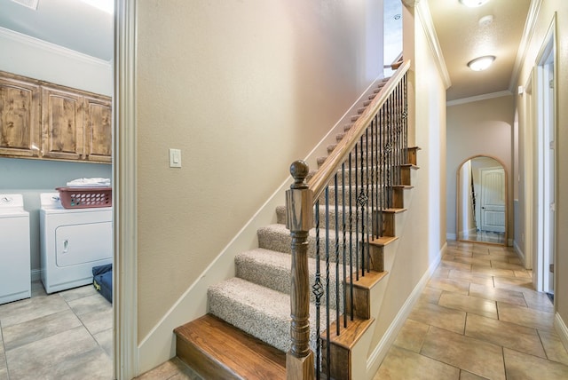 stairs featuring washing machine and dryer and ornamental molding