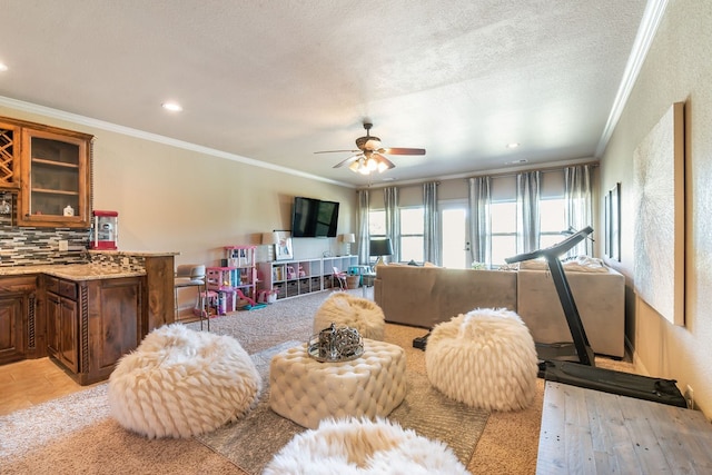 living room featuring crown molding, a textured ceiling, light hardwood / wood-style flooring, and ceiling fan