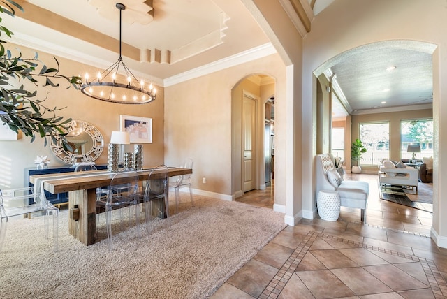 dining area featuring crown molding and a notable chandelier