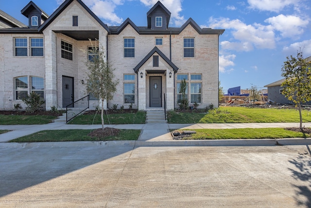 view of property featuring a front lawn