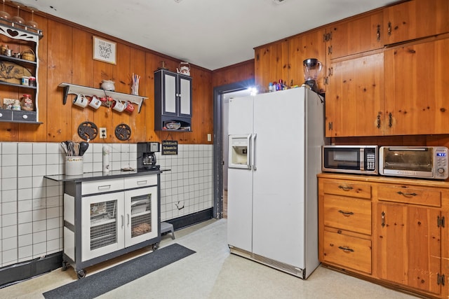 kitchen featuring tasteful backsplash and white fridge with ice dispenser