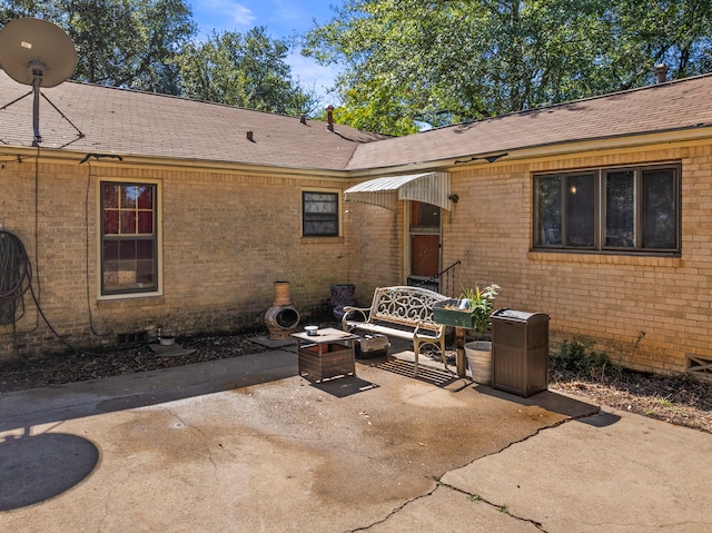 rear view of house featuring an outdoor fire pit and a patio