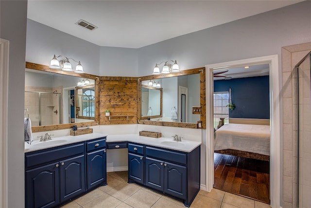 bathroom with vanity, an enclosed shower, and wood-type flooring