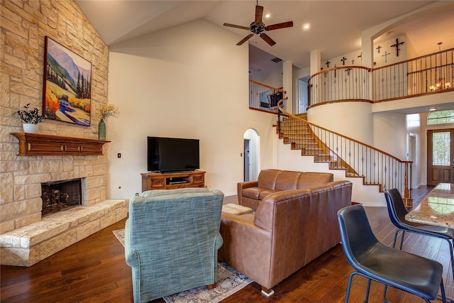 living room with high vaulted ceiling, dark wood-type flooring, a fireplace, and ceiling fan