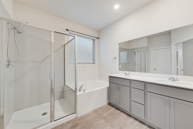 bathroom with vanity, plus walk in shower, and hardwood / wood-style floors