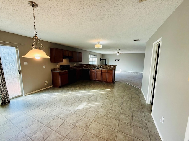 kitchen featuring decorative light fixtures, kitchen peninsula, electric range, a textured ceiling, and light carpet