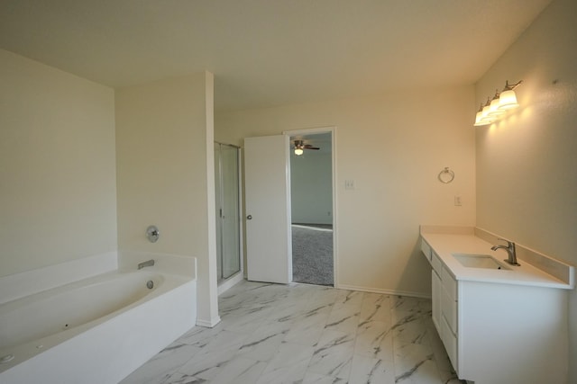 bathroom with marble finish floor, a shower stall, baseboards, a bath, and vanity