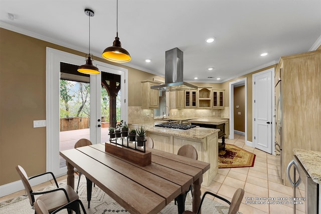 kitchen featuring decorative backsplash, island exhaust hood, light tile patterned floors, light stone countertops, and decorative light fixtures