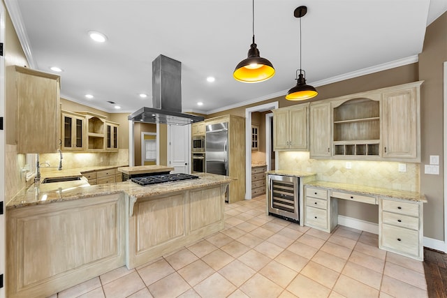 kitchen with sink, island range hood, kitchen peninsula, hanging light fixtures, and beverage cooler