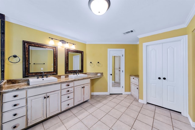 bathroom with vanity, ornamental molding, and tile patterned flooring