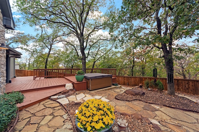 view of patio / terrace featuring a hot tub and a wooden deck