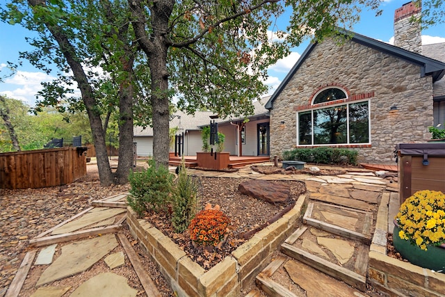 back of property with a patio area and a hot tub