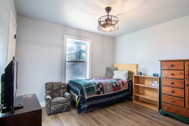 bedroom with hardwood / wood-style flooring