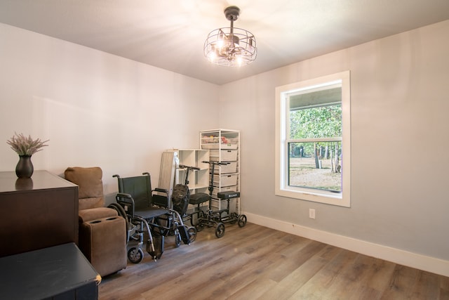 living area featuring light hardwood / wood-style flooring and an inviting chandelier