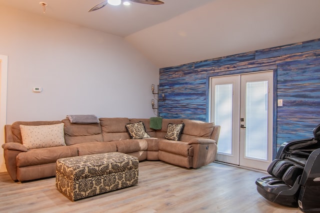 living room with french doors, vaulted ceiling, light wood-type flooring, and ceiling fan