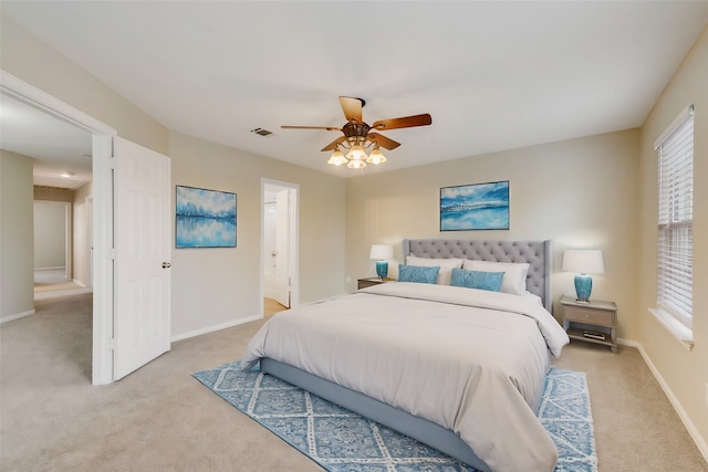 bedroom featuring light carpet, visible vents, baseboards, and ceiling fan