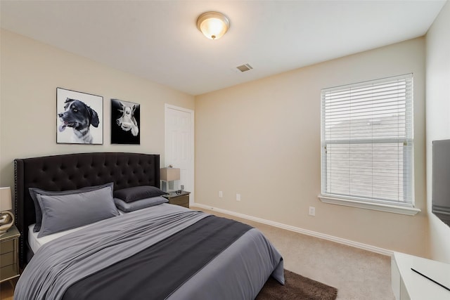 carpeted bedroom with visible vents and baseboards