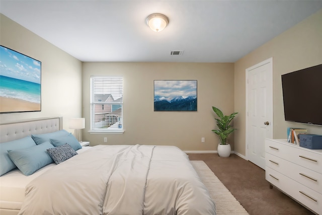 bedroom featuring dark colored carpet, visible vents, and baseboards