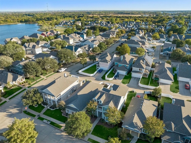 drone / aerial view with a water view and a residential view