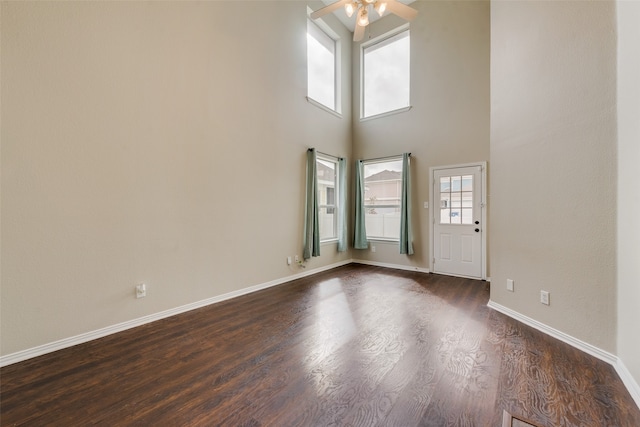 entryway featuring a high ceiling, dark hardwood / wood-style floors, and ceiling fan