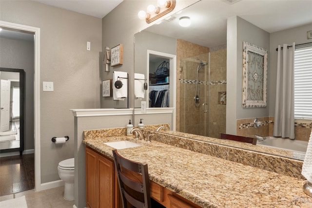 628 Destin Dr, Fort Worth, TX 76131 - full bathroom featuring a stall shower, toilet, vanity, tile patterned flooring, and baseboards