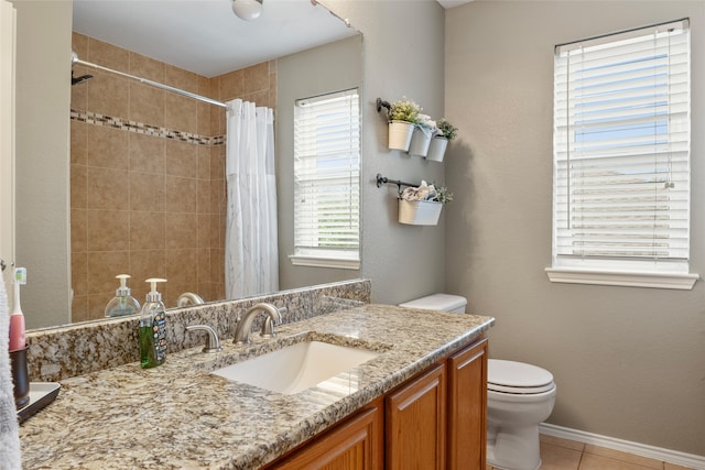 bathroom featuring toilet, walk in shower, vanity, and tile patterned floors