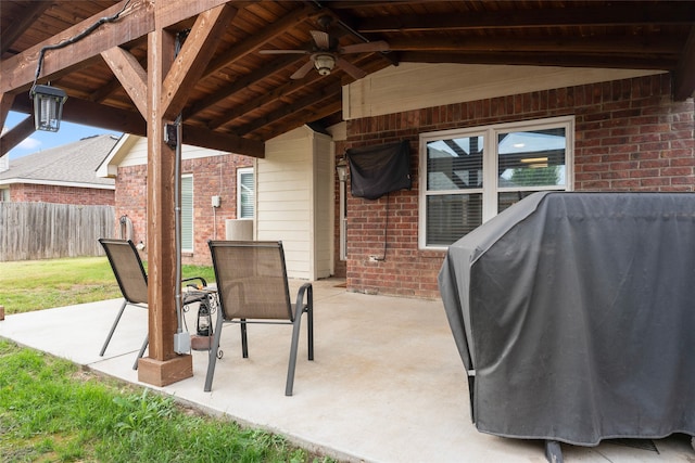 view of patio with ceiling fan and a grill