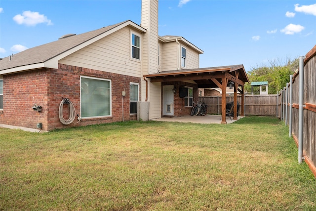 back of property with a patio area and a lawn