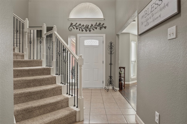 tiled foyer entrance with a high ceiling