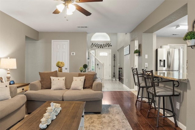 628 Destin Dr, Fort Worth, TX 76131 - living area featuring a ceiling fan, dark wood-style floors, baseboards, and stairs